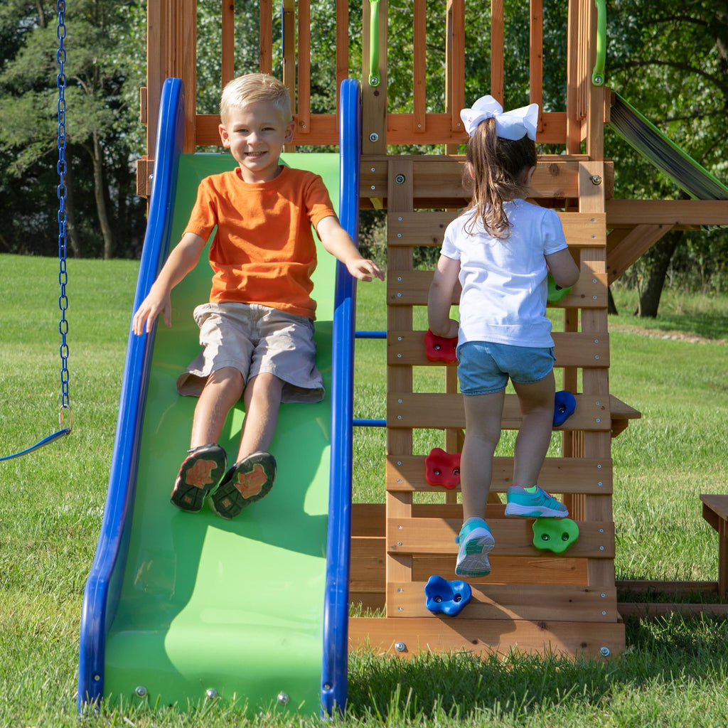 Backyard Discovery Beach Front Cedar Wood Swing Set with Wave Slide, Play Deck, Monkey Bars, Rock Wall Ladder, Shaded Picnic Area, Snack Bar, Belt Swings, Trapeze, Sandbox Area, Outdoor Playset